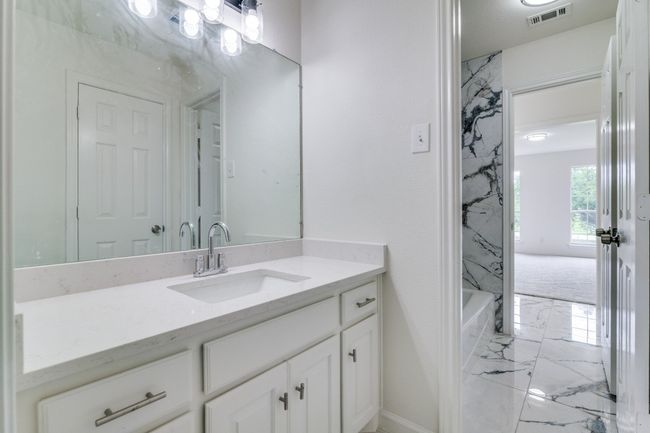 Bathroom with marble finish flooring, vanity, and baseboards | Image 20
