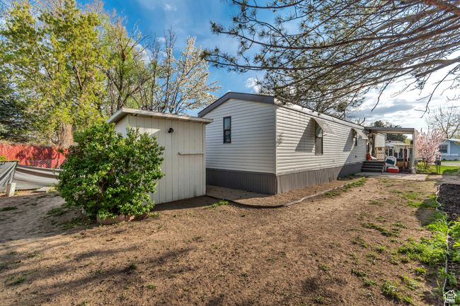 View of side of home with fence, an outbuilding, and a storage unit | Image 15