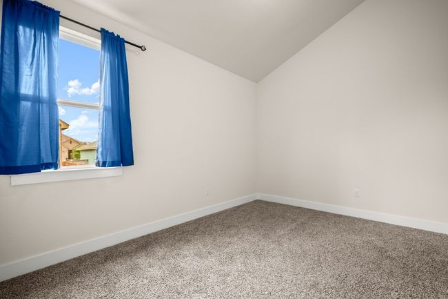 Unfurnished room with carpet and lofted ceiling | Image 7