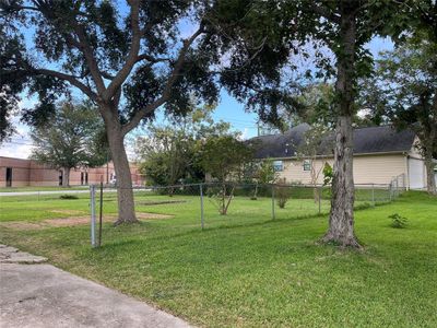 This is taken from the next door house's driveway, to give you perspective. The property line runs very close to the driveway shown. The front is 60 feet wide. | Image 3