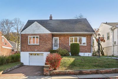 View of front of home with a garage and a front yard | Image 1