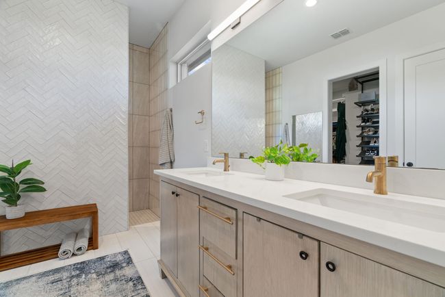 Full bathroom with double vanity, a walk in shower, and tile patterned floors | Image 33