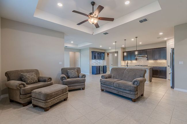 Living area featuring a raised ceiling, recessed lighting, a ceiling fan, and light tile patterned floors | Image 20