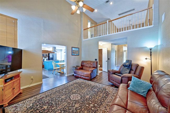 Open-concept family room flows effortlessly into the kitchen and breakfast area, perfect for gatherings. | Image 9