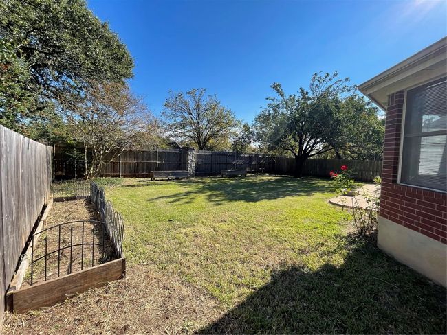 View of fenced backyard | Image 31