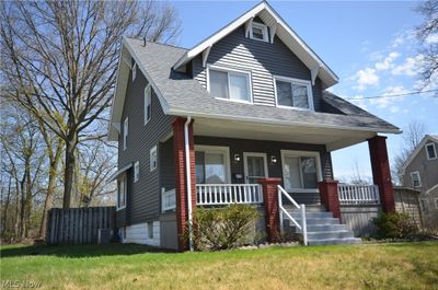 View of front of property featuring a front yard, central air condition unit, and covered porch | Image 3