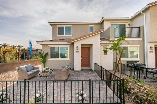 View of property with a tiled roof, outdoor lounge area, stucco siding, a patio, and fence | Image 10