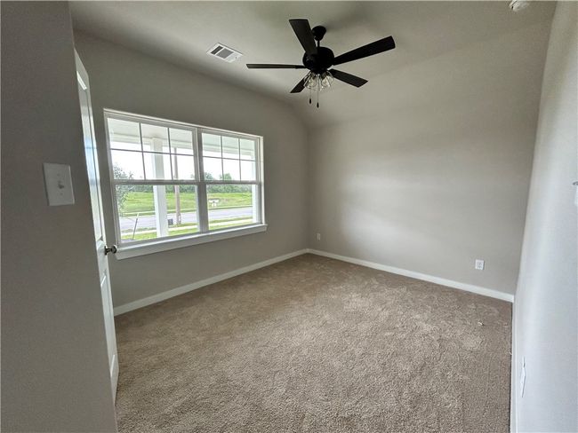 Bedroom with carpet flooring and a ceiling fan | Image 12