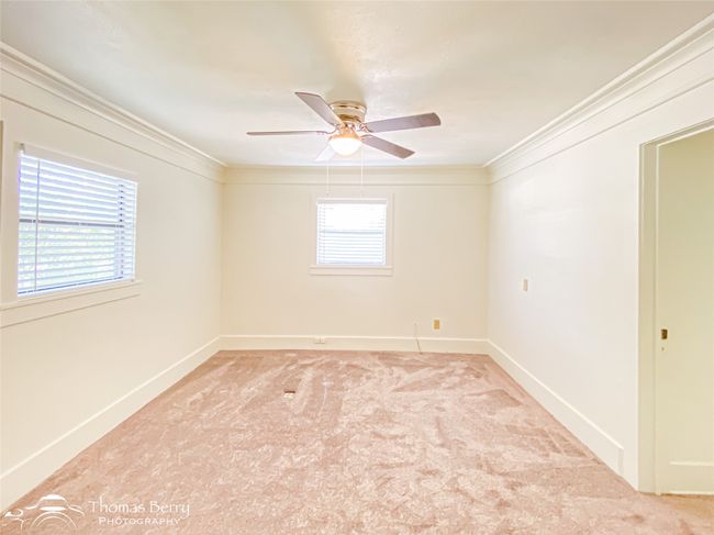 Spare room with crown molding, ceiling fan, and carpet flooring | Image 20