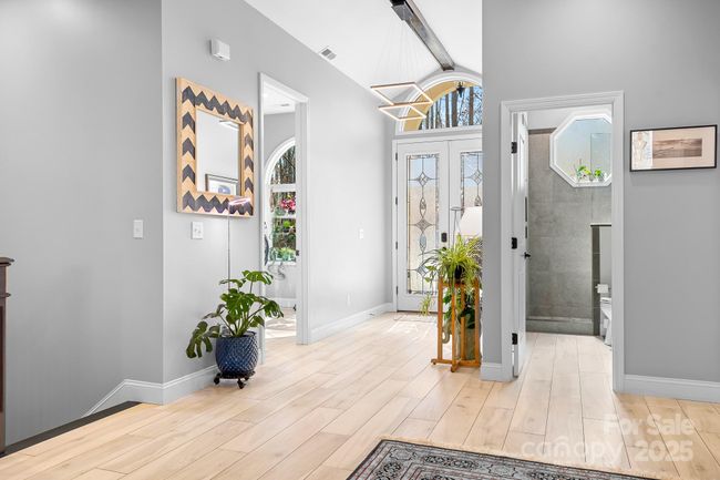 Foyer entrance space with Stain Glass insert double doors, Arched windows, and Modern design elements. | Image 34