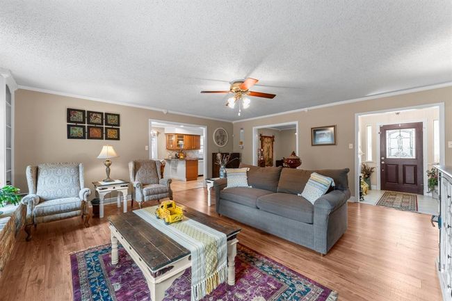This spacious living room is oversized and a great gathering area with a central fireplace. | Image 4