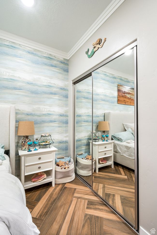 Bedroom with crown molding and a closet | Image 56