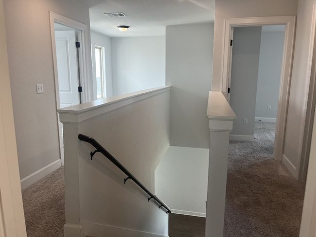 Stairs featuring visible vents, carpet, and baseboards | Image 33