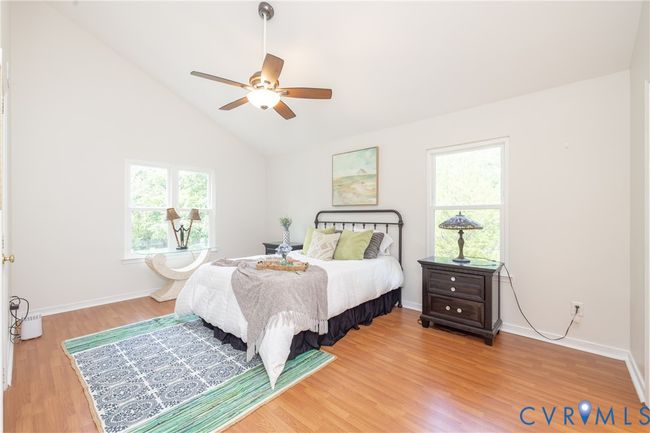 Bedroom with multiple windows, light wood-type flooring, high vaulted ceiling, and ceiling fan | Image 20