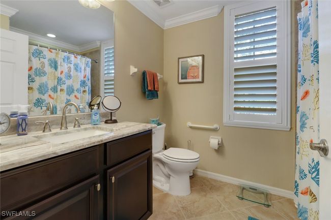 Bathroom featuring tile patterned flooring, vanity, crown molding, toilet, and baseboards | Image 19