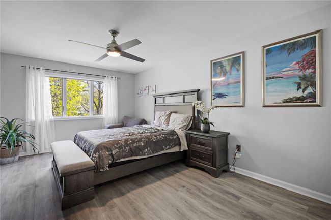 Bedroom featuring wood finished floors and a ceiling fan | Image 30