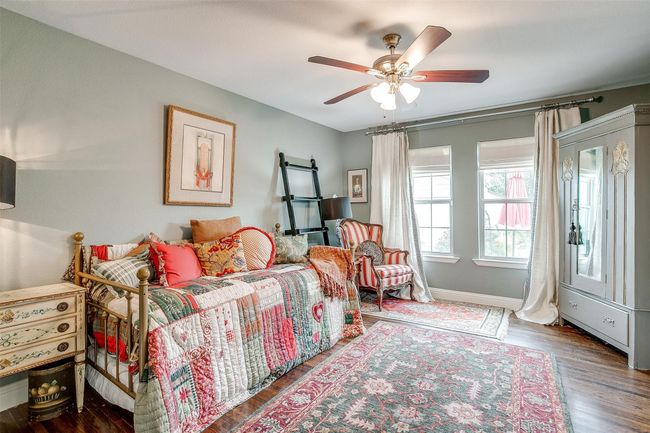 Bedroom featuring baseboards, wood finished floors, and a ceiling fan | Image 6