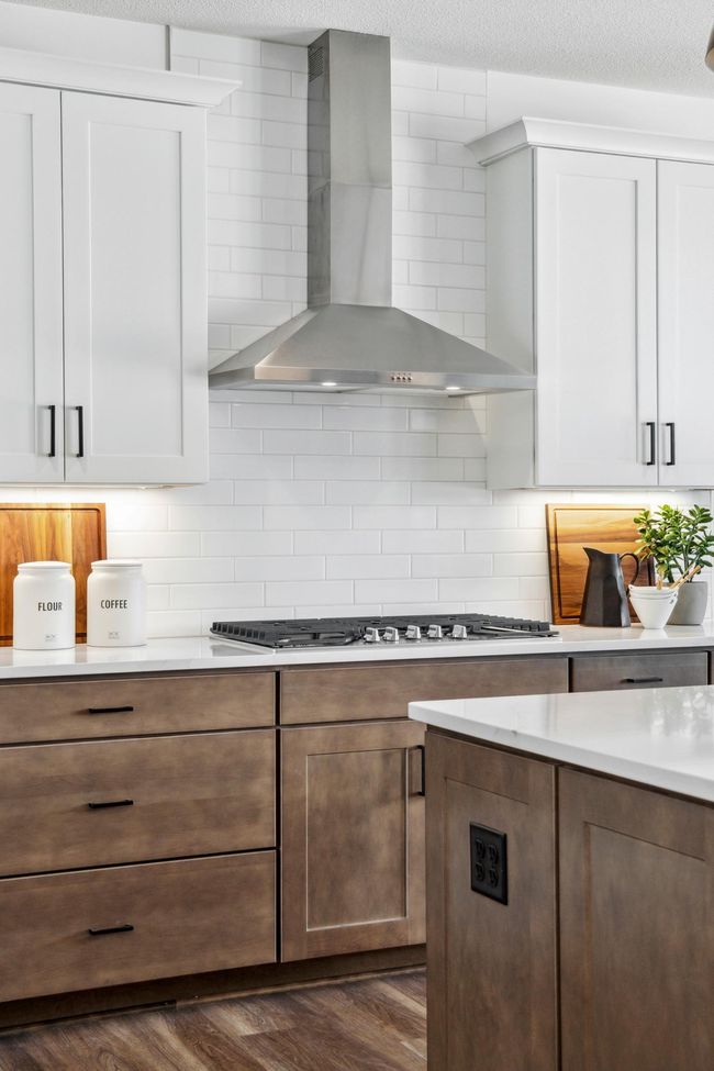 Photo is of a model home. (Some features shown may be different) This home will feature a wood vent hood. | Image 12