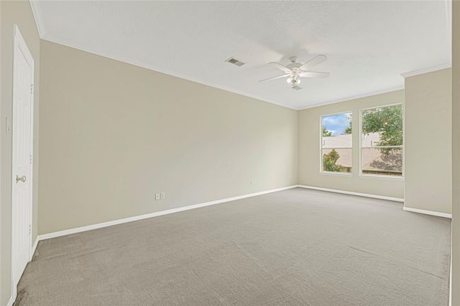 Spacious back bedroom with abundant natural light. | Image 44