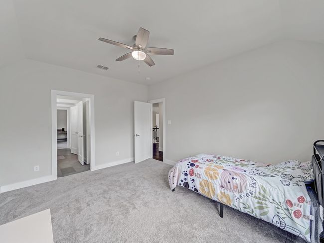 Carpeted bedroom featuring baseboards, ceiling fan, and vaulted ceiling | Image 18