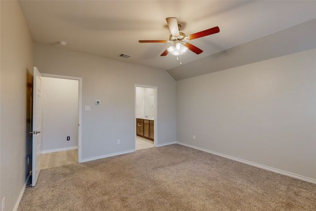 Unfurnished bedroom with baseboards, ceiling fan, light carpet, and ensuite bathroom | Image 36