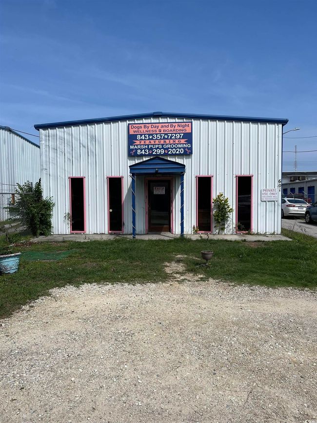 View of building exterior with a detached garage | Image 6