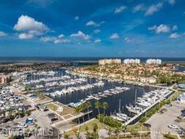 Bird's eye view of numerous boat docks and a nearby body of water | Image 38