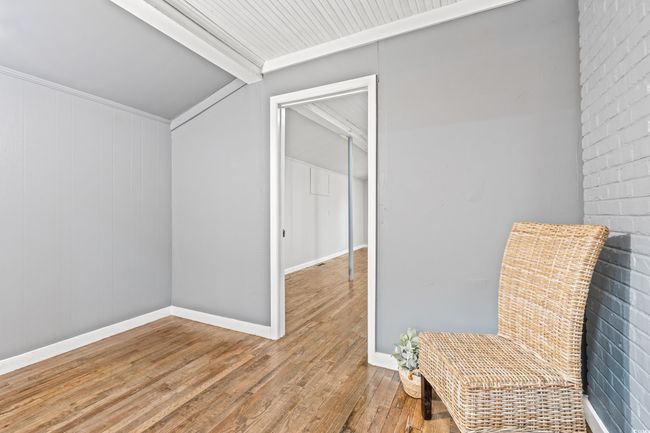 Unfurnished room featuring wood finished floors and vaulted ceiling | Image 17