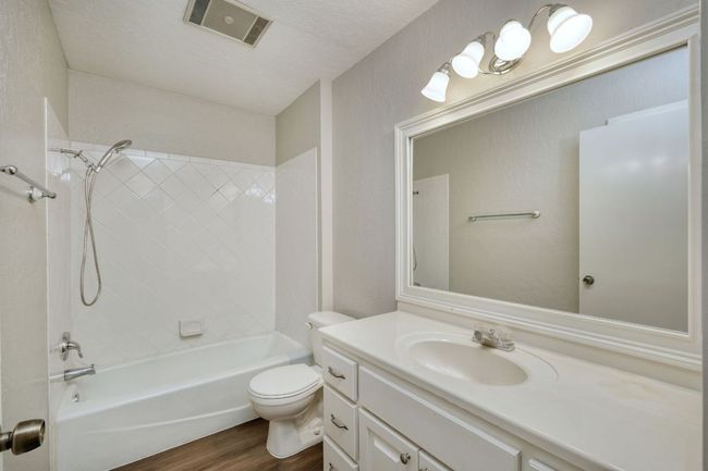 Bathroom with vanity, wood finished floors, and tub / shower combination | Image 10