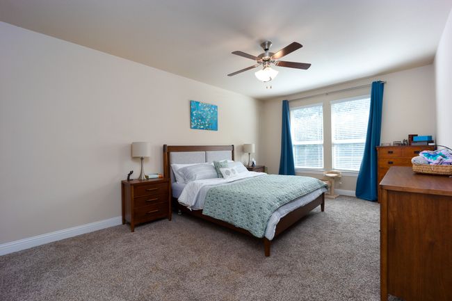 Carpeted bedroom with baseboards and ceiling fan | Image 12