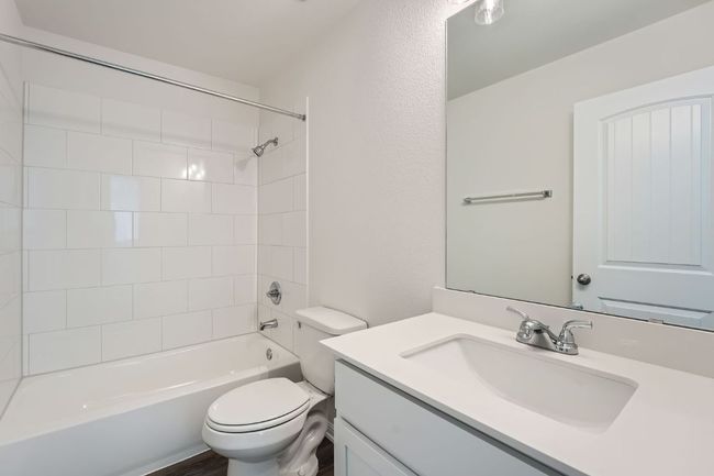 Bathroom with toilet, vanity, and washtub / shower combination | Image 21