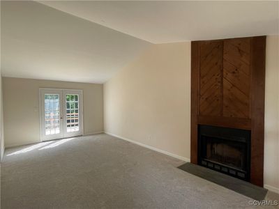 fireplace, and lofted ceiling in great room | Image 3