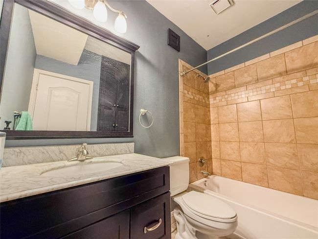 Bathroom featuring vanity and shower / bath combination | Image 20