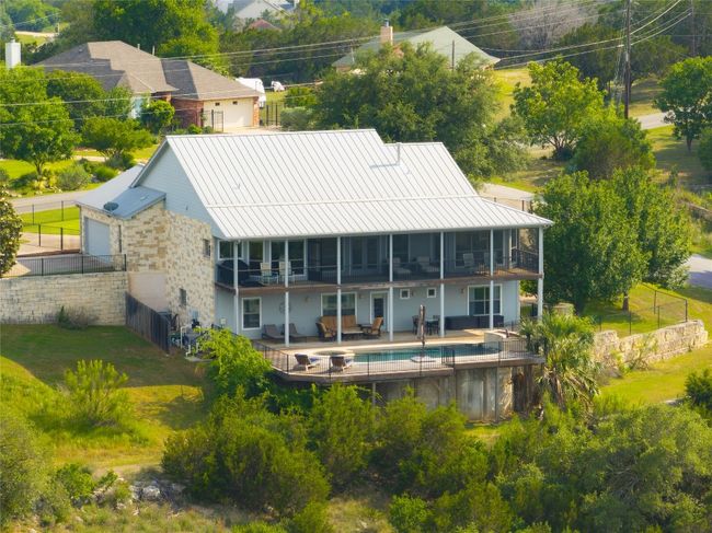 Back of house featuring a patio, metal roof, a standing seam roof, and a balcony | Image 38