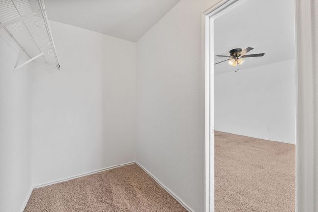 Spacious closet featuring carpet flooring and ceiling fan | Image 34