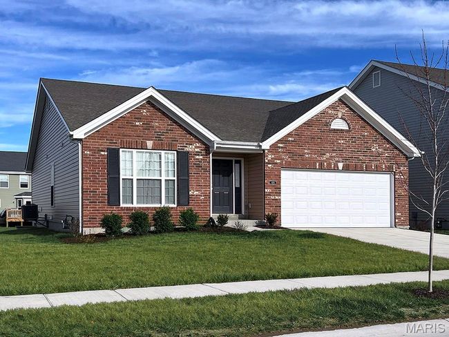 Single story home featuring an attached garage, a front yard, concrete driveway, and brick siding | Image 26