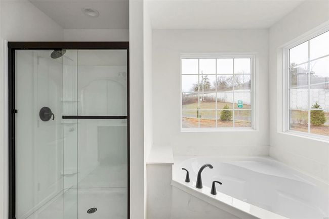 Bathroom featuring plenty of natural light and separate shower and tub | Image 5