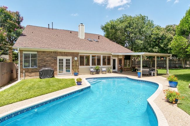 View of pool with french doors, a fenced backyard, a patio, and area for grilling | Image 23
