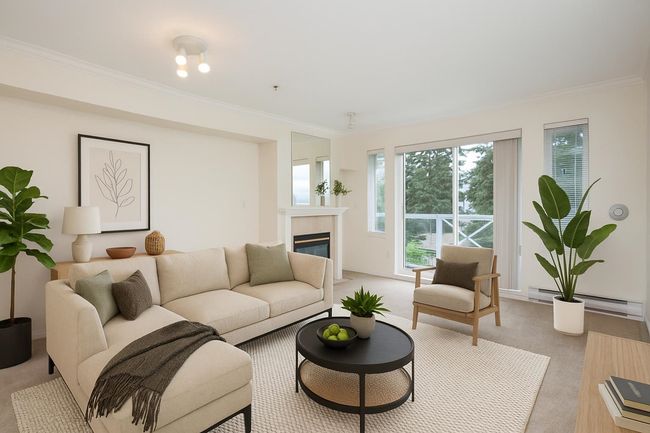 Living room featuring light carpet, baseboard heating, crown molding, and a glass covered fireplace | Image 4
