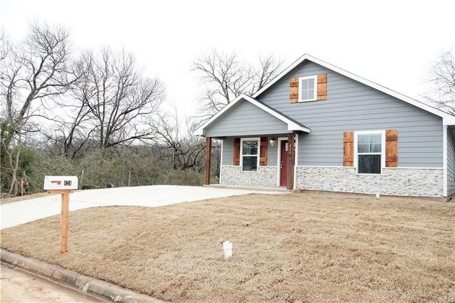 Doorway to property featuring covered porch and stone siding | Image 18