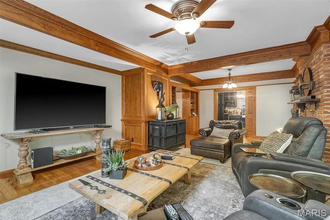 Living room with ceiling fan, light wood-style floors, and crown molding | Image 55