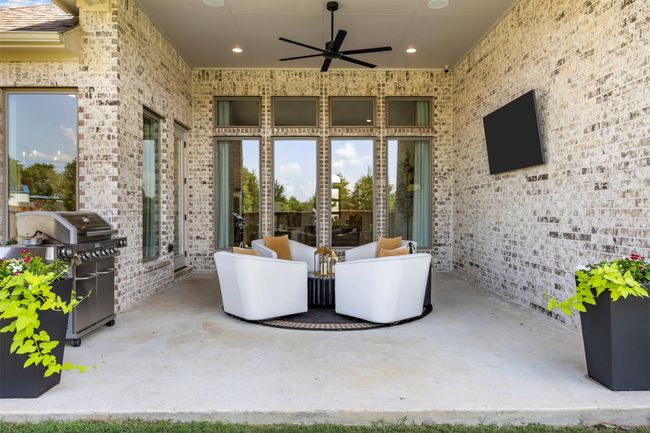 View of patio featuring ceiling fan and area for grilling | Image 34