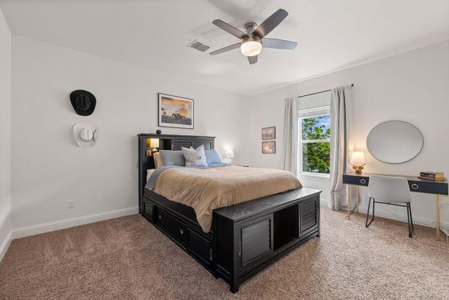 Bedroom with carpet flooring, a ceiling fan, baseboards, and visible vents | Image 33