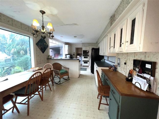 Spacious kitchen with stunning backyard views. | Image 7
