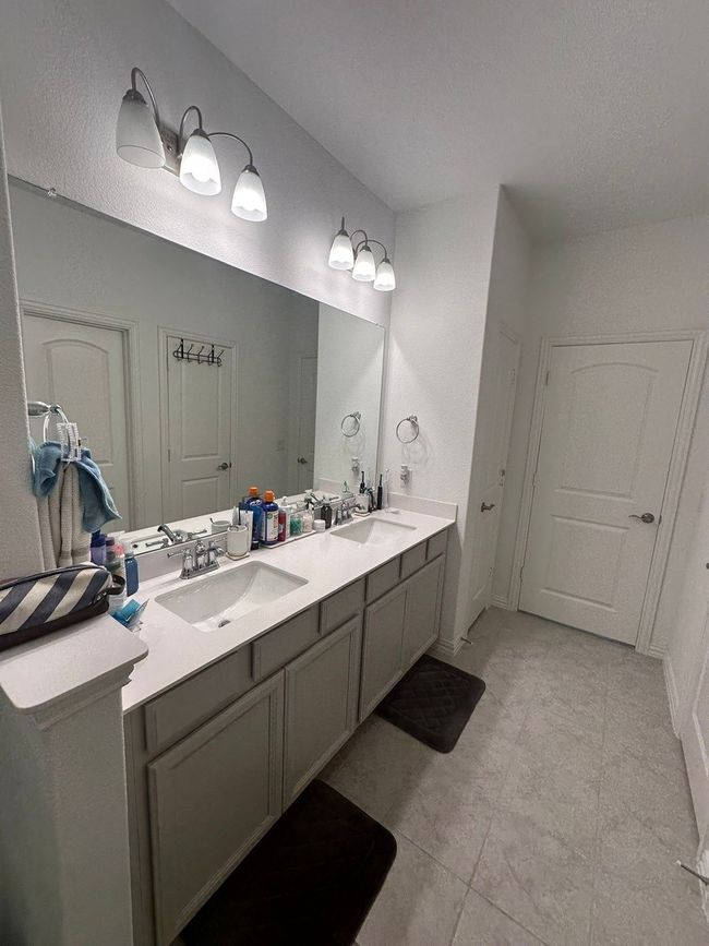 Bathroom with double vanity and tile patterned flooring | Image 9