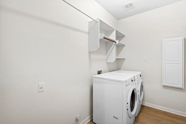 Laundry area with washing machine and dryer and light wood-type flooring | Image 27