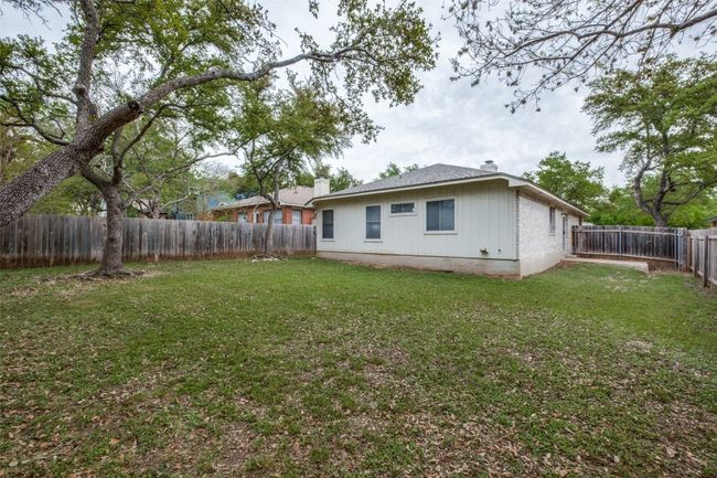 Back of property featuring a yard, a fenced backyard, and a chimney | Image 24