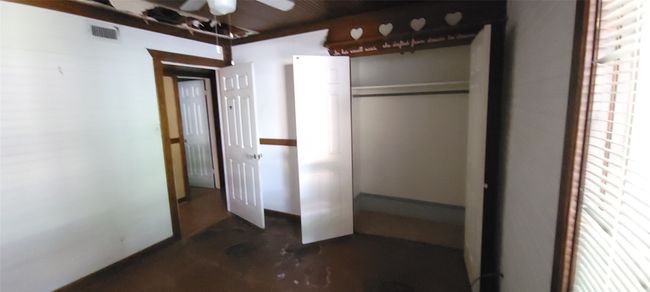 Unfurnished bedroom with concrete flooring | Image 14