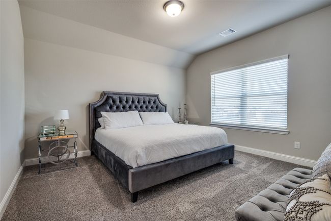 Carpeted bedroom with vaulted ceiling | Image 32