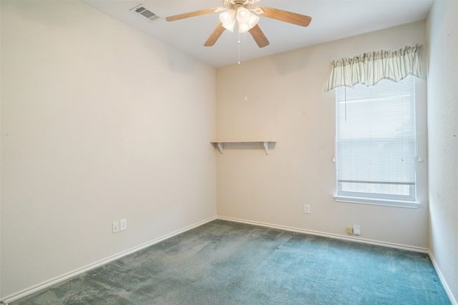 Middle bedroom with carpet floors, baseboards, visible vents, and ceiling fan | Image 20